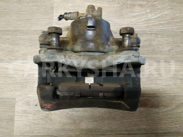 Суппорт тормозной передний левый Nissan Primera оригинальный номер 410112F021